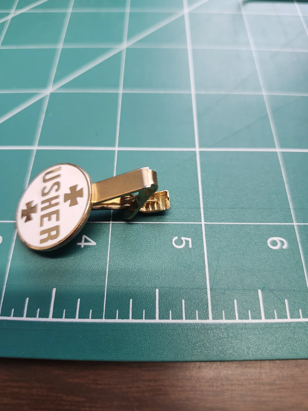 Usher Gold and White Enamel Logo Brooch Tie Clip
